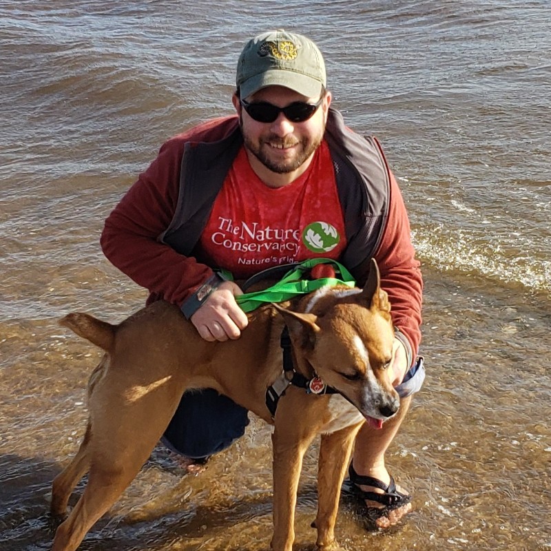 Mike and his dog, Scout, on a beach in Staten Island